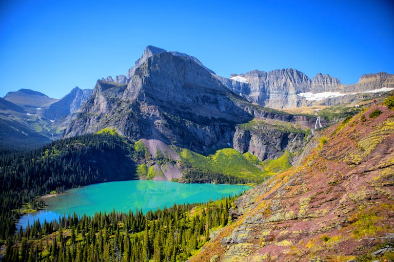Breathtaking view of turquoise lake and mountains in Glacier National Park.